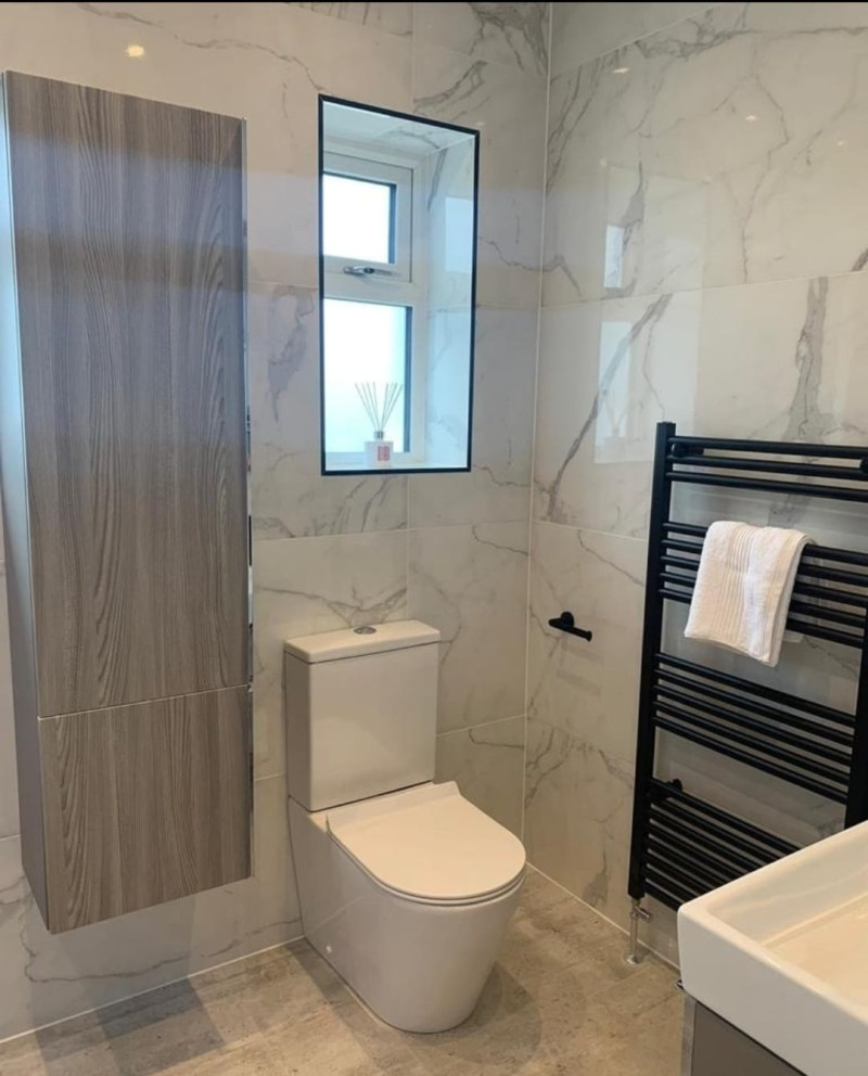 Black slate effect tray with 600x1200 Carrara porcelain tile, black dual function concealed Vale, 800 wall hung unit and matching tall boy fitted in bathroom renovation project in Templeogue, Dublin by A&R Bathrooms