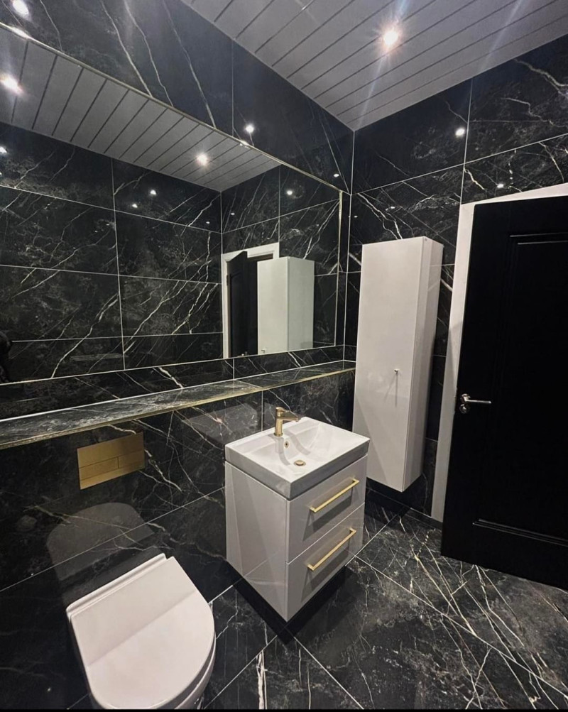 New wall hung wash basin and matching tall boy with Spanish 600x1200 wall and floor tile in guest toilet room supplied and fitted by A&R Bathrooms, Ireland